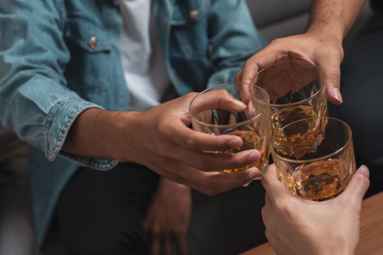 Men toasting with glasses of whiskey