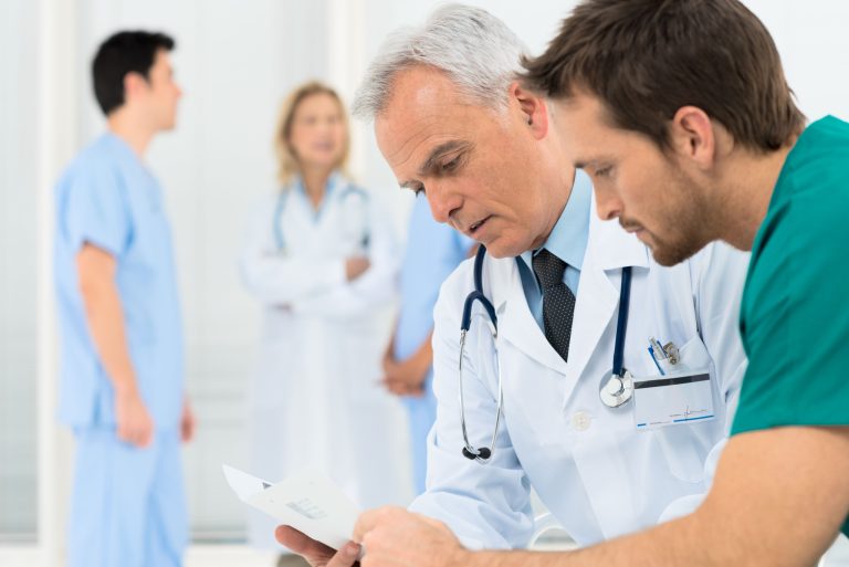 A doctor and patient reading a paper document