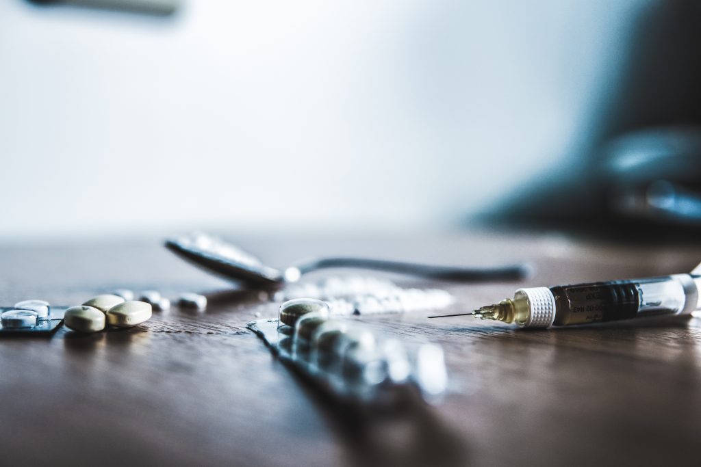 Drugs and syringes arranged on a table