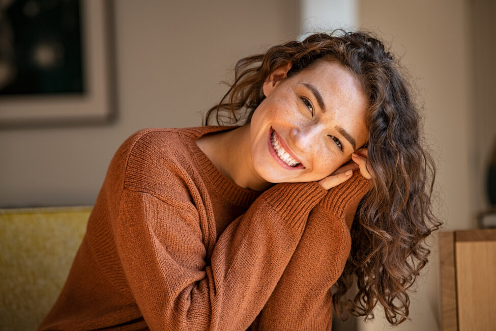 Smiling woman seated on a couch