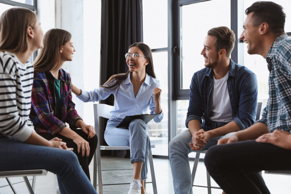 People sitting in a circle engaged in discussion