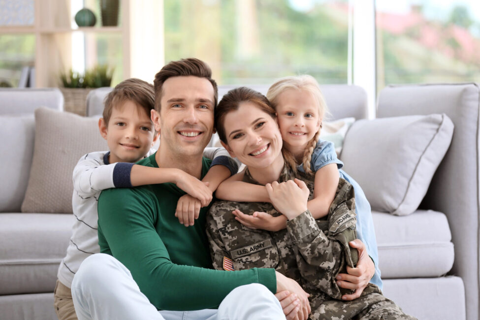A family sitting on the floor in front of a couch